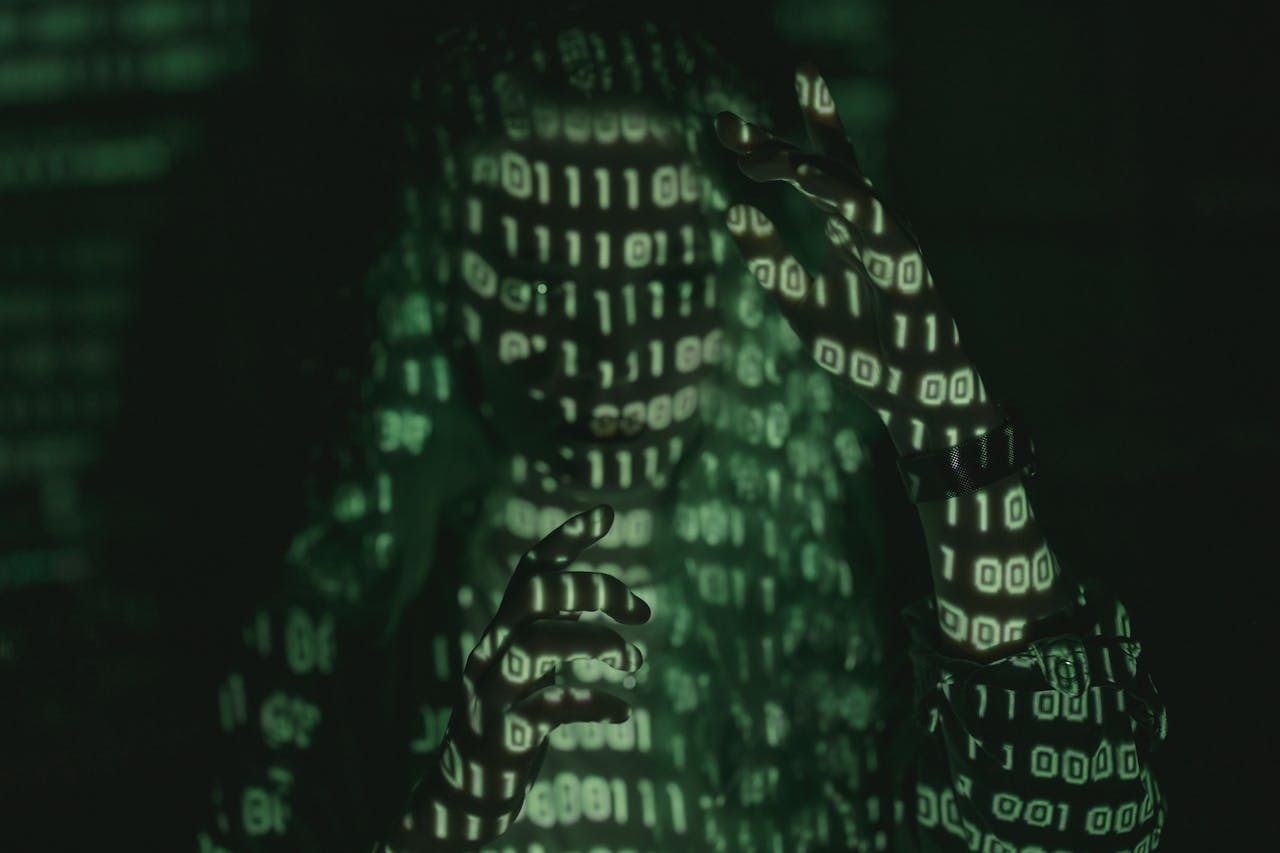 who-we-are-img An unrecognizable person with binary code projected, symbolizing cybersecurity and digital coding.