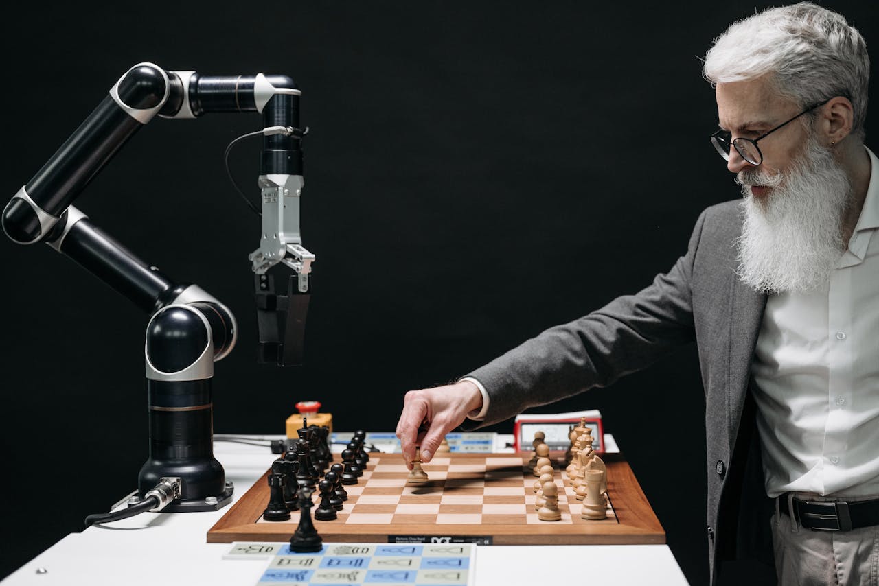 our-journey-01 A bearded man strategically moves chess pieces while an AI robot arm assists in a futuristic game.